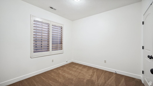 unfurnished room featuring a textured ceiling, visible vents, baseboards, and carpet floors