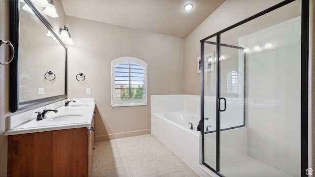 bathroom with baseboards, a bath, vaulted ceiling, and a sink