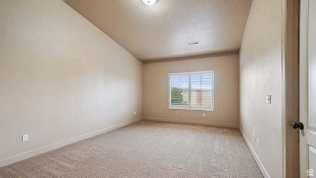 carpeted empty room with baseboards, visible vents, and a textured ceiling