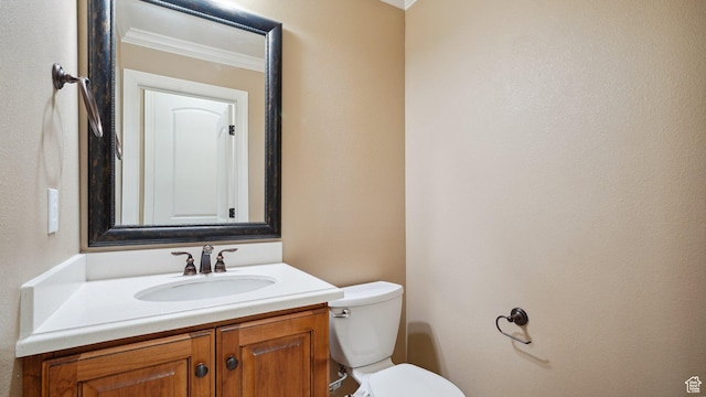 bathroom featuring ornamental molding, toilet, and vanity