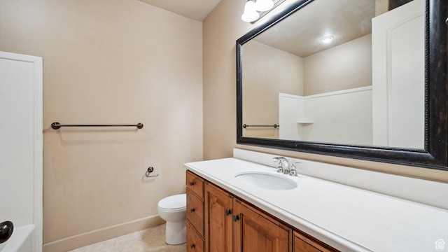 bathroom with baseboards, toilet, tile patterned flooring, and vanity
