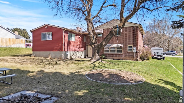 162 S 3 E, Preston, ID 83263 - back of house with a lawn, a chimney, fence, and brick siding