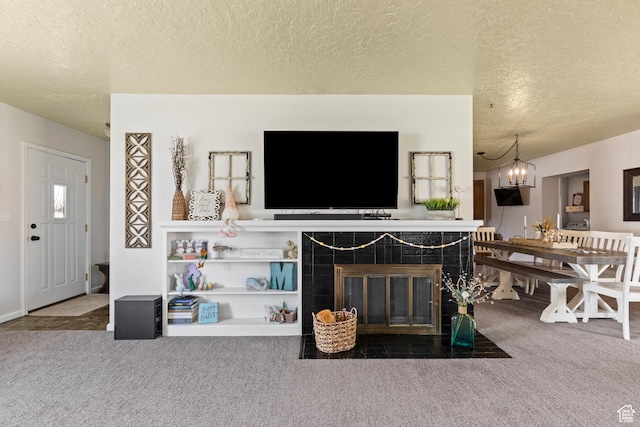 162 S 3 E, Preston, ID 83263 - carpeted living room featuring a textured ceiling, a fireplace, and an inviting chandelier