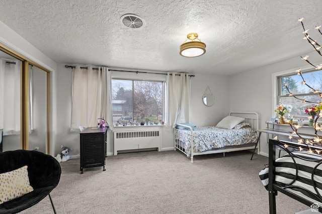 162 S 3 E, Preston, ID 83263 - bedroom featuring a textured ceiling, visible vents, baseboards, radiator heating unit, and carpet floors