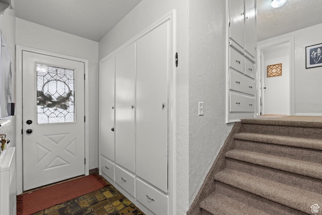 162 S 3 E, Preston, ID 83263 - foyer entrance featuring a textured wall, brick floor, and stairs