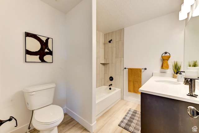full bath featuring bathtub / shower combination, wood finished floors, baseboards, vanity, and toilet