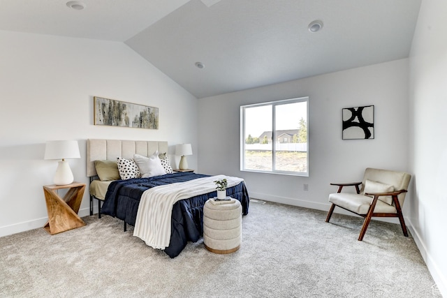 carpeted bedroom featuring baseboards and lofted ceiling