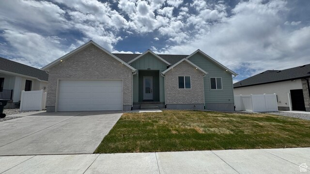 445 W 1910 N Unit 318, Tooele, UT 84074 - view of front of property with a garage, concrete driveway, brick siding, and board and batten siding