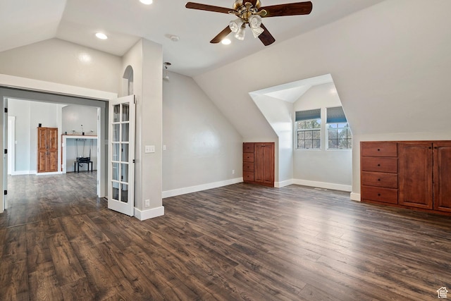 additional living space featuring vaulted ceiling, ceiling fan, dark wood-type flooring, and baseboards