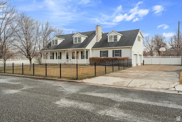 cape cod-style house featuring a garage, a fenced front yard, a chimney, and concrete driveway