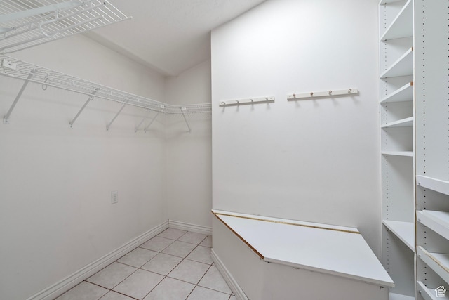 spacious closet featuring light tile patterned flooring