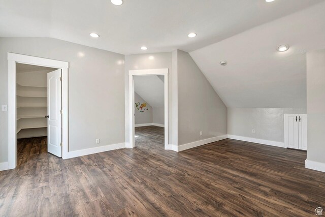 additional living space with lofted ceiling, dark wood-style floors, baseboards, and recessed lighting