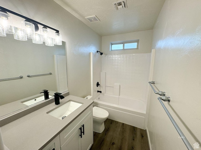 bathroom with toilet, visible vents,  shower combination, and wood finished floors