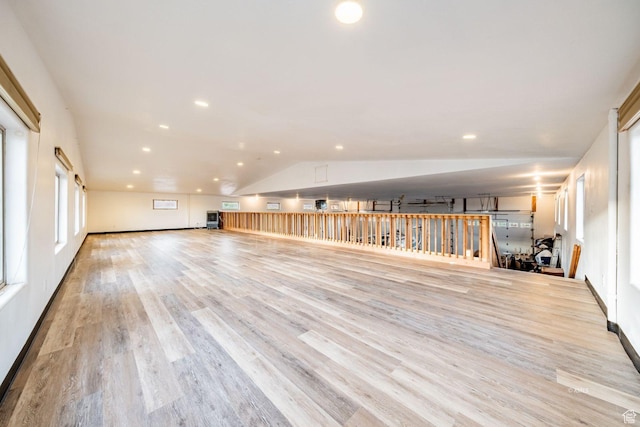 spare room with vaulted ceiling, light wood-style flooring, and recessed lighting