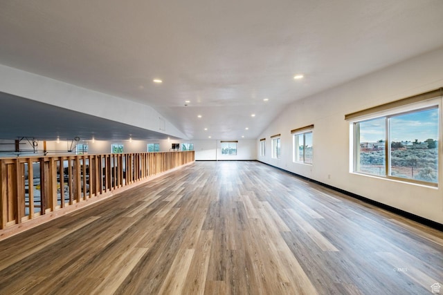 unfurnished room with lofted ceiling, wood finished floors, and recessed lighting