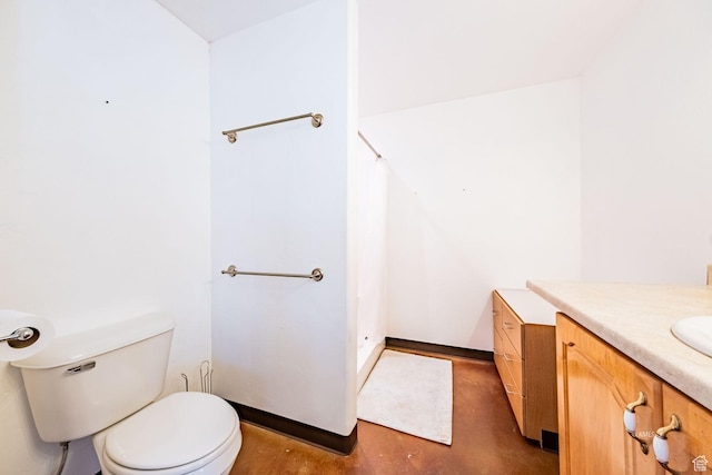 full bathroom with finished concrete floors, vanity, toilet, and walk in shower