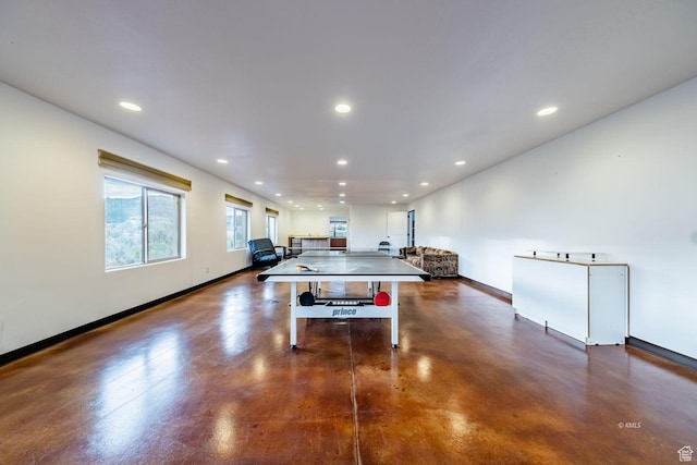 playroom with finished concrete flooring, recessed lighting, and baseboards