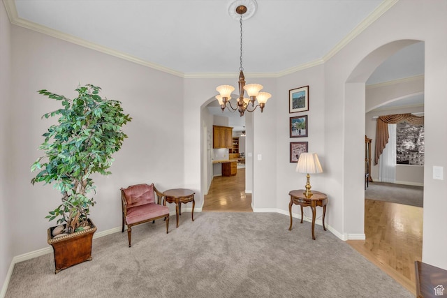 living area with a notable chandelier, arched walkways, crown molding, and carpet floors