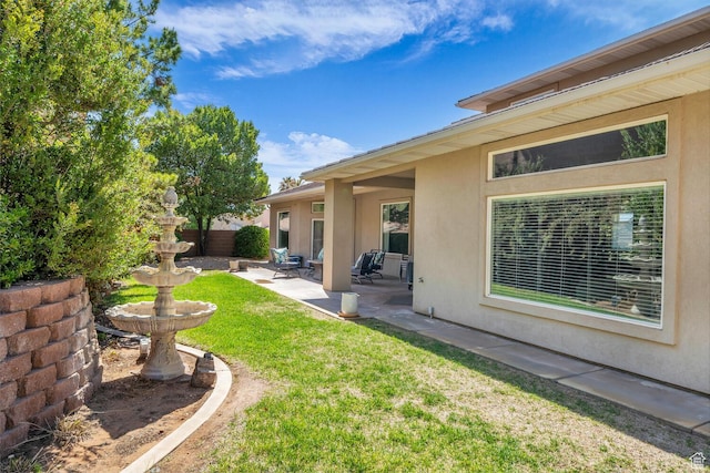 view of yard featuring a patio and fence