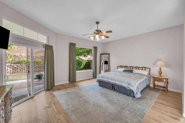 bedroom featuring light wood-style floors, access to exterior, a ceiling fan, and baseboards