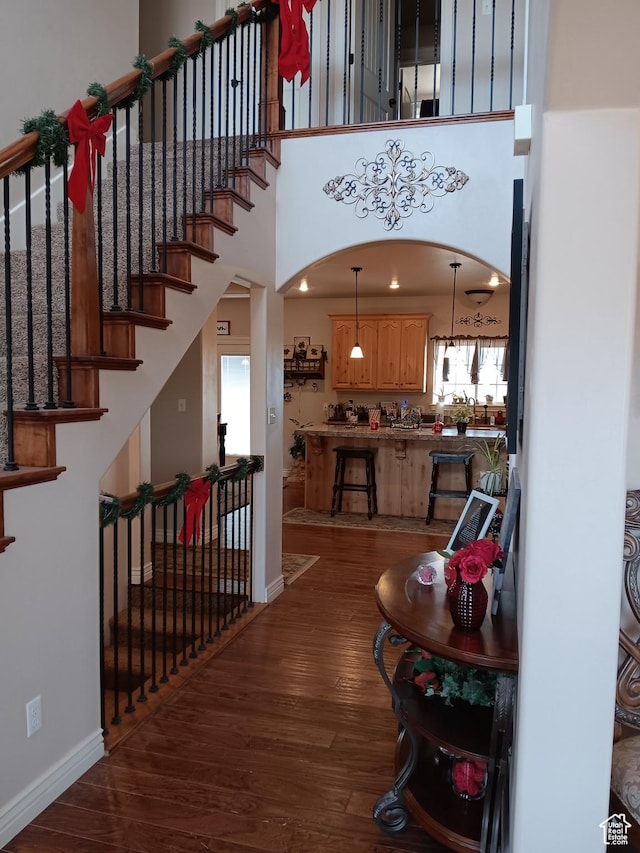 4680 N 4500 W, Cedar City, UT 84721 - entrance foyer featuring baseboards, arched walkways, dark wood-style floors, stairway, and a high ceiling