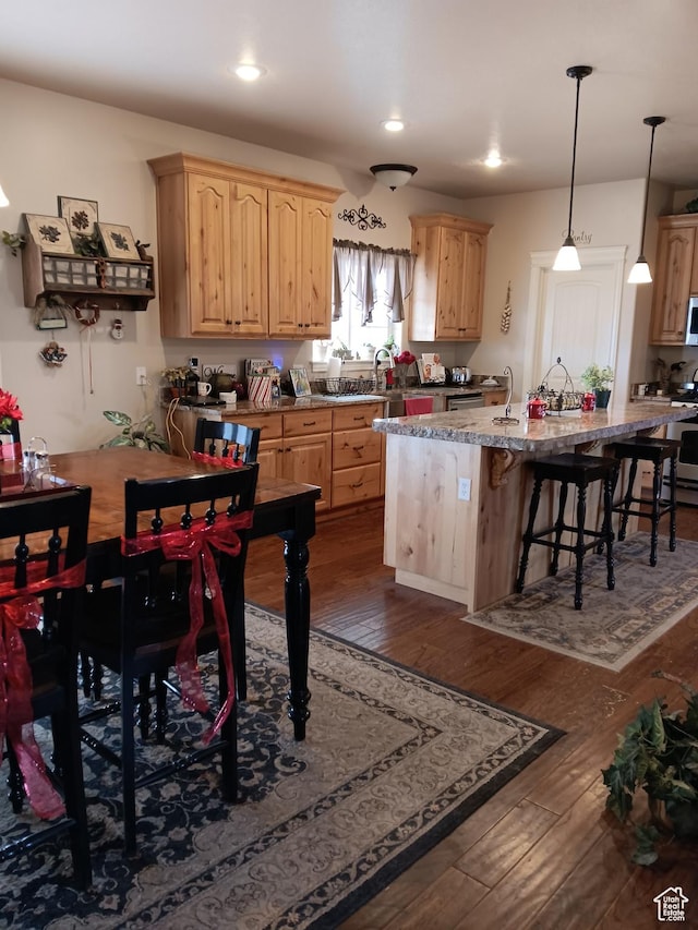 4680 N 4500 W, Cedar City, UT 84721 - kitchen featuring light brown cabinets, recessed lighting, dark wood-style flooring, an island with sink, and a kitchen bar