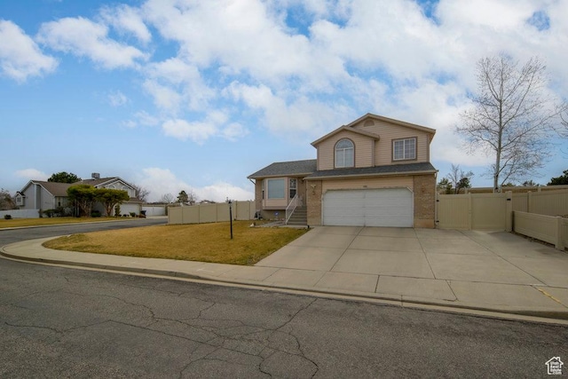 view of front of home with a garage, a gate, fence, and concrete driveway