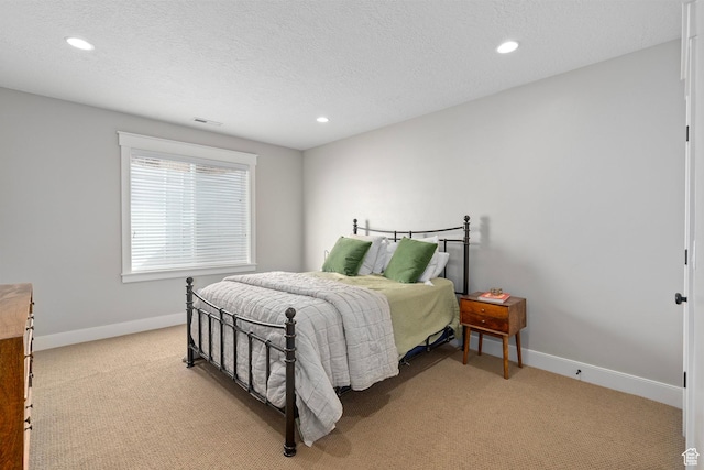 bedroom with light carpet, recessed lighting, baseboards, and a textured ceiling