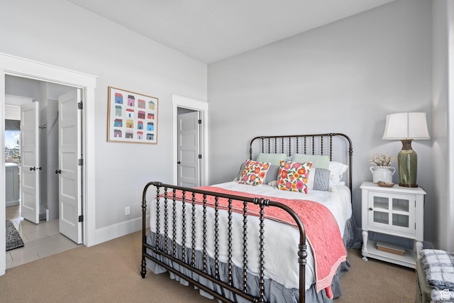 bedroom featuring baseboards, carpet, and ensuite bathroom