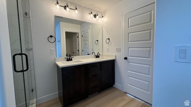 463 W 1910 N Unit 320, Tooele, UT 84074 - full bath with double vanity, a shower stall, a sink, and wood finished floors