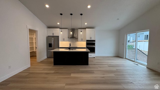 463 W 1910 N Unit 320, Tooele, UT 84074 - kitchen with wall chimney exhaust hood, appliances with stainless steel finishes, vaulted ceiling, and white cabinets