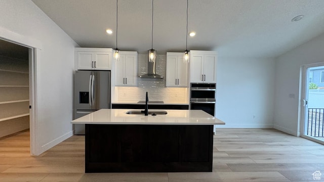 463 W 1910 N Unit 320, Tooele, UT 84074 - kitchen with baseboards, wall chimney exhaust hood, appliances with stainless steel finishes, and white cabinets