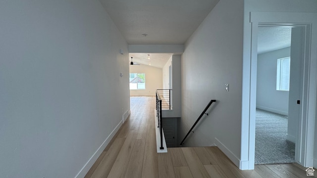 463 W 1910 N Unit 320, Tooele, UT 84074 - hallway with baseboards, lofted ceiling, wood finished floors, and an upstairs landing