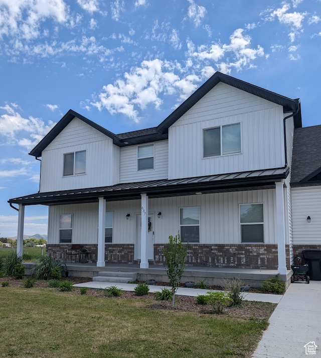 637 S 4th W, Preston, ID 83263 - view of front of house with a porch, a standing seam roof, metal roof, brick siding, and a front lawn
