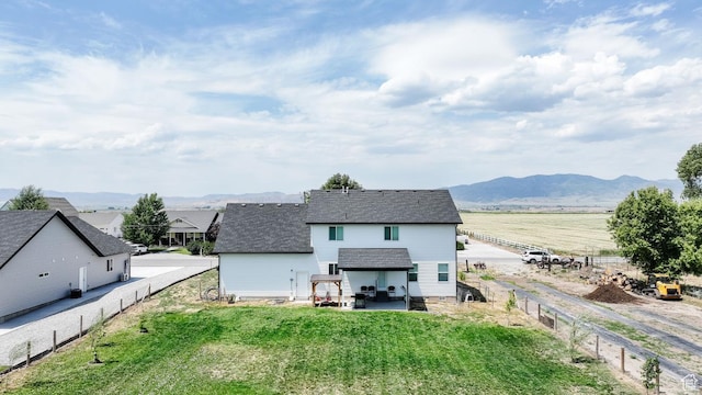 637 S 4th W, Preston, ID 83263 - back of house featuring a patio area, a mountain view, and a shingled roof