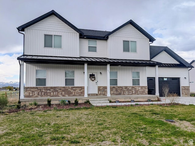 view of front facade with a porch, a standing seam roof, an attached garage, and brick siding