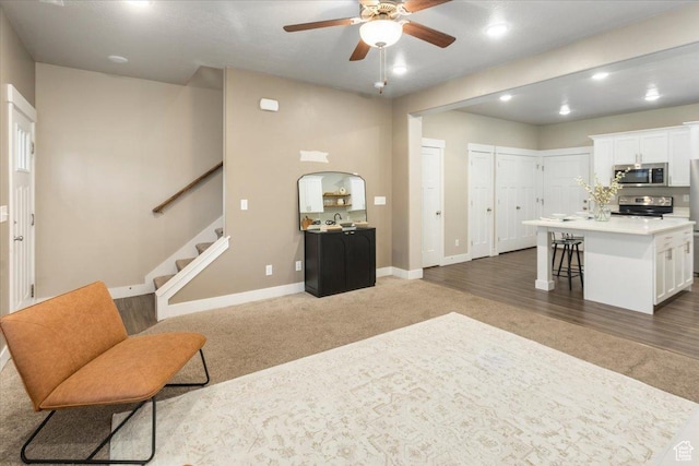 1704 E Talon Way, Eagle Mountain, UT 84005 - carpeted living room featuring stairway, baseboards, ceiling fan, and recessed lighting