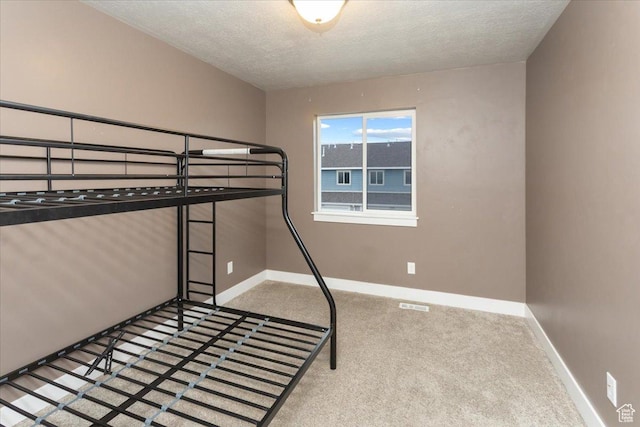 1704 E Talon Way, Eagle Mountain, UT 84005 - unfurnished bedroom with baseboards, carpet flooring, a textured ceiling, and visible vents