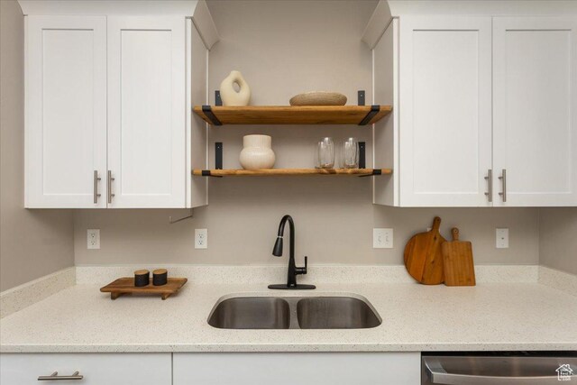 1704 E Talon Way, Eagle Mountain, UT 84005 - kitchen featuring white cabinets, light stone countertops, a sink, and dishwasher