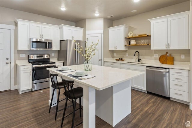 1704 E Talon Way, Eagle Mountain, UT 84005 - kitchen with a sink, a center island, stainless steel appliances, and dark wood finished floors