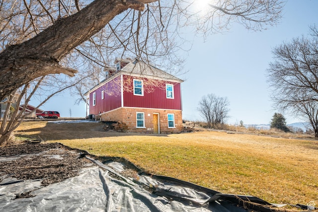 view of property exterior with a lawn
