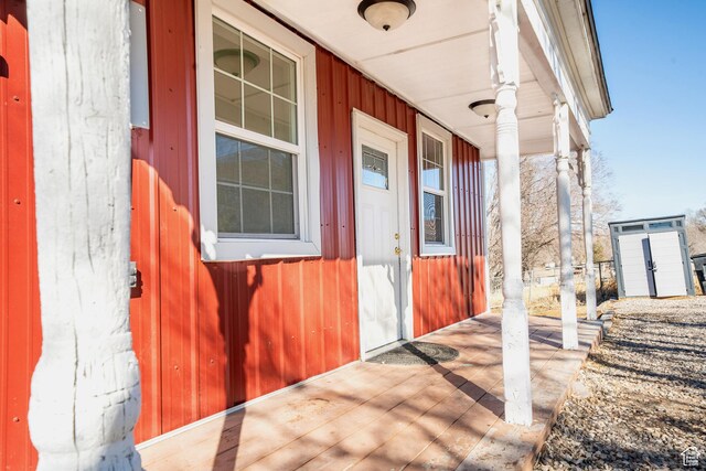 view of exterior entry featuring covered porch