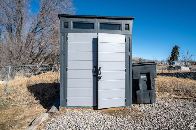 view of shed with fence