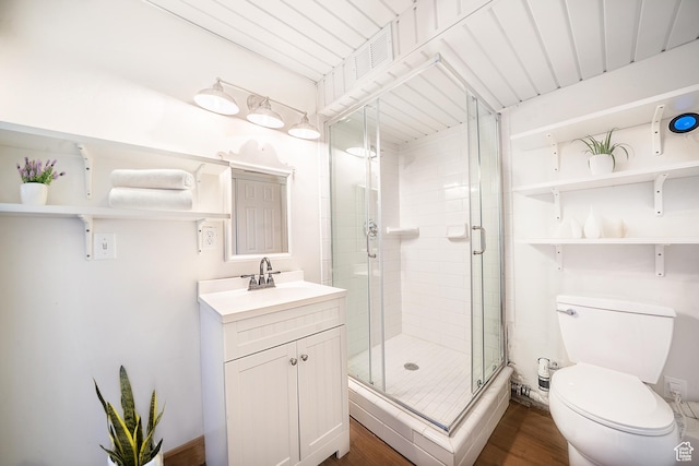 full bathroom featuring toilet, a shower stall, wood finished floors, and vanity