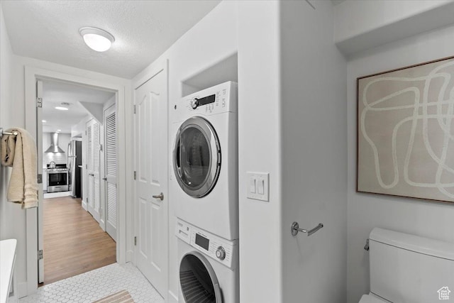 251 N Center St W, Salt Lake City, UT 84103 - clothes washing area featuring light tile patterned floors, a textured ceiling, and stacked washer / drying machine