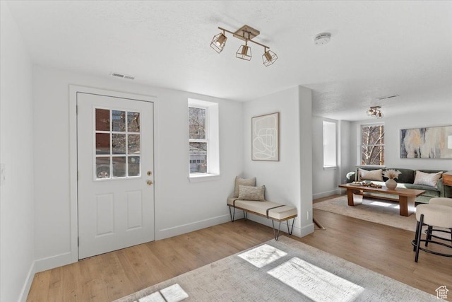 251 N Center St W, Salt Lake City, UT 84103 - entrance foyer featuring baseboards, a textured ceiling, visible vents, and wood finished floors