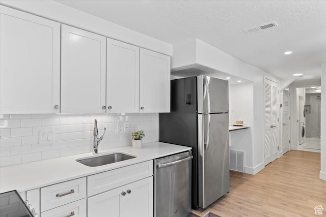 251 N Center St W, Salt Lake City, UT 84103 - kitchen with white cabinetry, visible vents, appliances with stainless steel finishes, and a sink