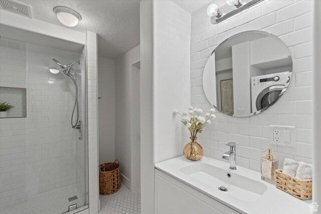 251 N Center St W, Salt Lake City, UT 84103 - bathroom featuring visible vents, a textured ceiling, vanity, a shower stall, and backsplash