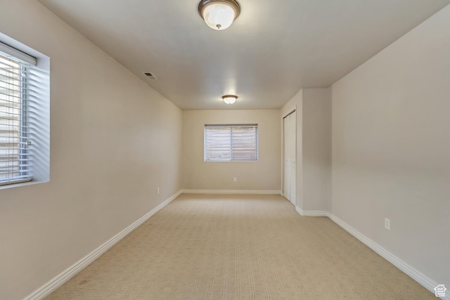 empty room with visible vents and baseboards