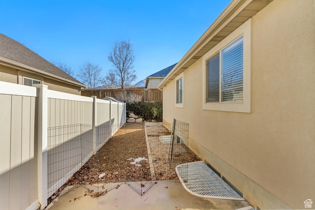 view of home's exterior with fence and stucco siding